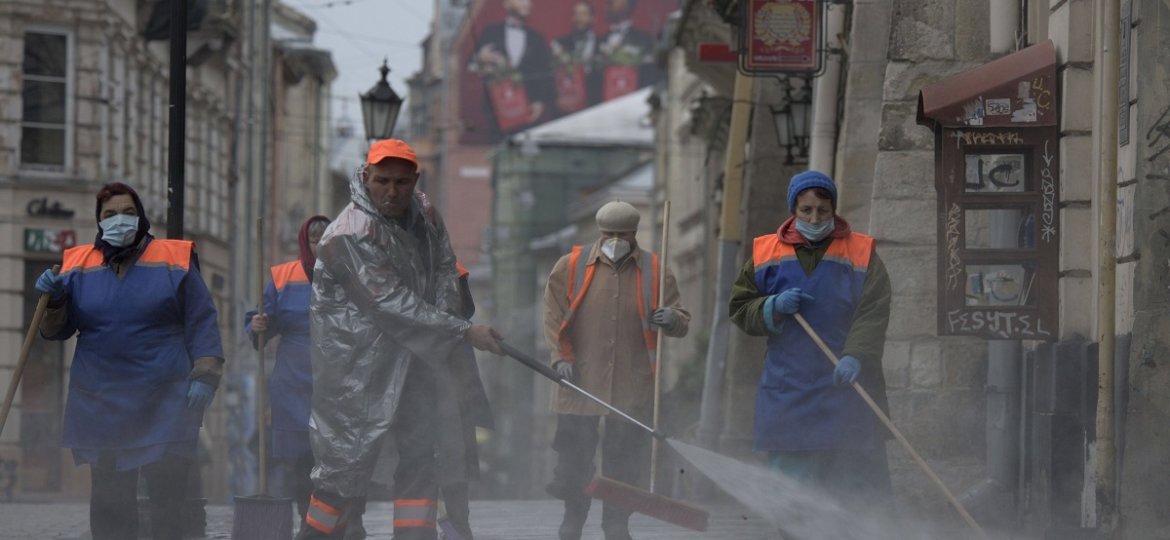LVIV, UKRAINE - MARCH 20, 2020 - Utility people wash the street with a disinfectant during the quarantine in Lviv, weste