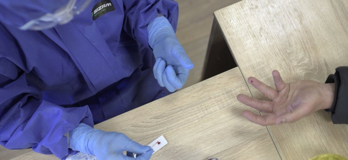 LVIV, UKRAINE - APRIL 01, 2020 - Medical worker runs a blood test for antibodies to SARS-COV-2 virus on a public transpo