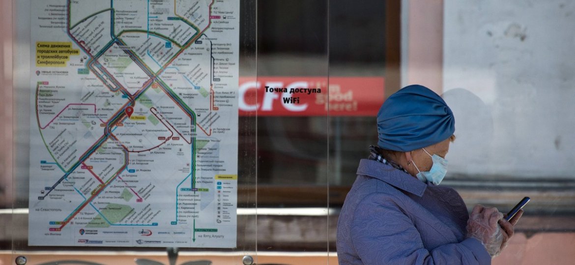SIMFEROPOL, CRIMEA, RUSSIA - APRIL 6, 2020: A woman seen at a bus stop in Kirova Street amid the ongoing COVID-19 corona
