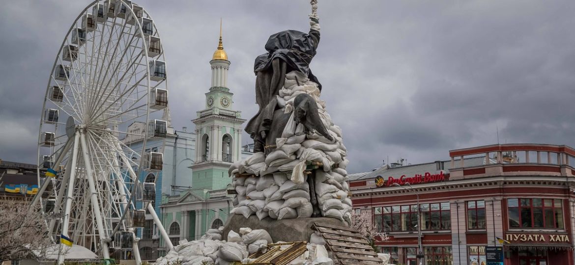 Photograph of an equestrian sculpture of Grigory Skovoroda covered with sandbags to protect it from possible attacks, in